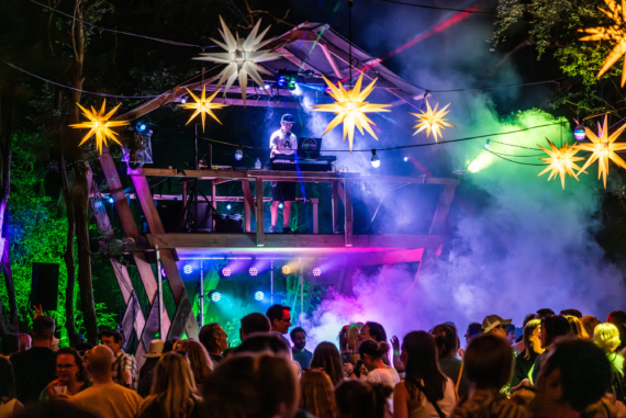 A stage is lit with a band on it.